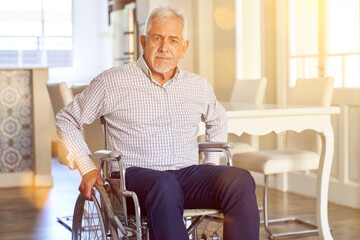 Senior man in wheelchair after stroke in nursing home