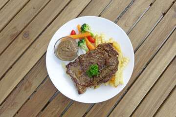 Wagyu steak served with vegetables and French fries. Selective focus