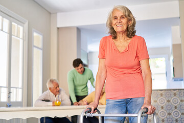 Elderly woman with a rollator as a walking aid after a stroke