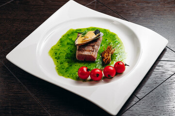 Grilled tuna steak with vegetable with cherry tomatoes, mussel and sauce