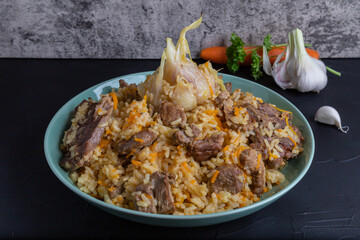 Uzbek national rice dish plov prepared on plate.