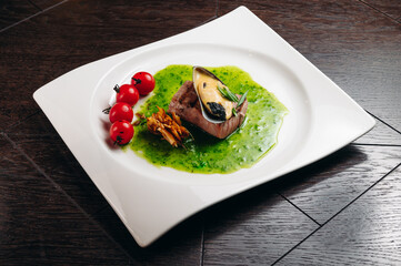 Grilled tuna steak with vegetable with cherry tomatoes, mussel and sauce