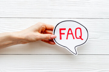 Hands with faq - frequently asked questions - text on paper bubble