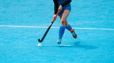 Young hockey player woman with ball in attack playing field hockey game. Horizontal sport poster,...