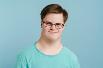 Young man with down syndrome smiling and looking at camera