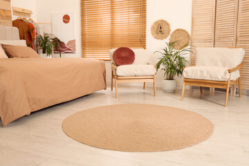 Bedroom interior with stylish furniture and straw rug
