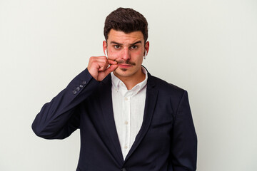 Young business caucasian man wearing wireless headphones isolated on white background with fingers on lips keeping a secret.