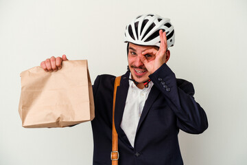 Young business caucasian man wearing bike helmet and holding take way food isolated on white background excited keeping ok gesture on eye.