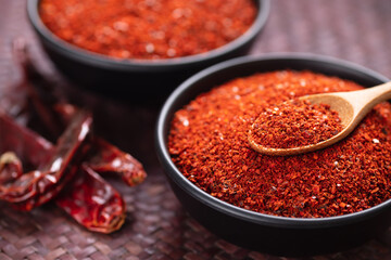 Red chili pepper powder in a bowl with spoon, Chili flakes