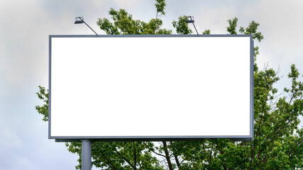 advertisement banner of white colour located near green tree