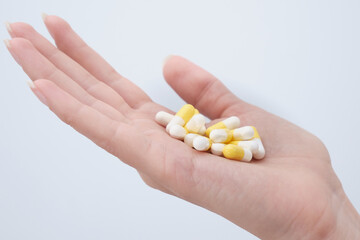 The capsules with the medicine are placed in the palm of the patient's hand
