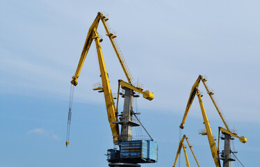 Cranes construction on the blue sky
