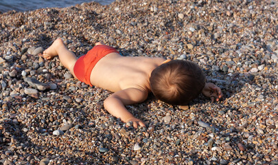 Little boy on a rocky beach