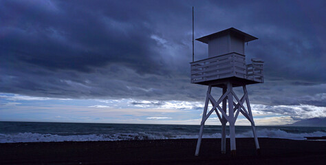 Beach tower with grey sky and rough sea