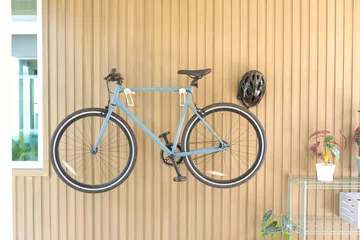 Fotobehang Bicycle hanged on wooden wall at house. © bennnn