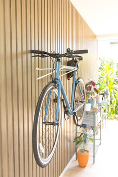 Bicycle hanged on wooden wall at house.