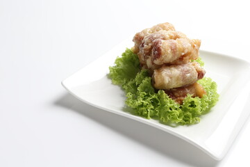 crispy deep fried bacon roll meat in white black background dim sum snack halal menu