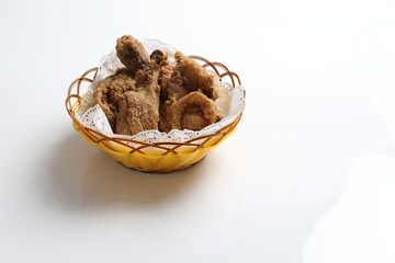 deep fried crispy chicken meat in basket in white black background dim sum snack halal menu