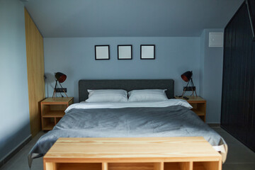 Background image of minimal house interior with focus on comfortable cozy bed in blue color, copy space