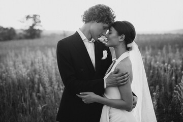 Young wedding couple together in field