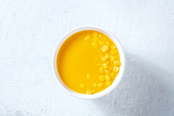 Sweet corn cream soup, shot from above. Simple vegan appetizer recipe