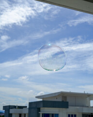 A large soap bubble is floating with apartment background.