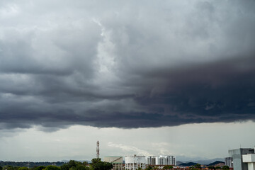 Fototapeta na wymiar Suburban city under the dark storm clouds before rain.
