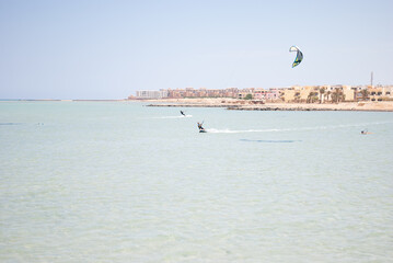 Kitesurfing on the shores of the sea against the backdrop of a stone African city