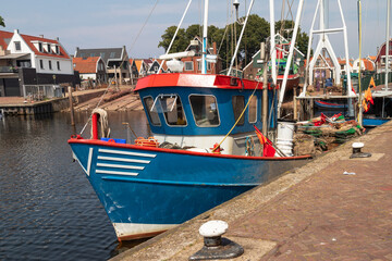 Fishing boat with nets in the harbor of the fishing village of Urk.