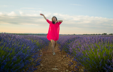 young happy and beautiful Asian Japanese woman in Summer dress enjoying nature free and playful outdoors at purple lavender flowers field in romantic beauty and freedom concept