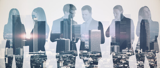 Businesspeople working together on abstract city background. Team work and success concept. Double exposure.