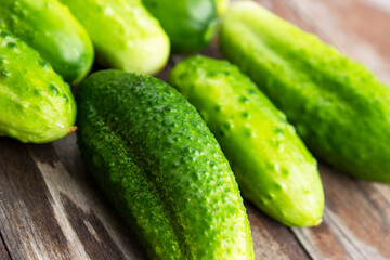 Sliced green cucumbers over a wooden cutting board