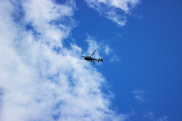 Fototapeta na wymiar A fighter jet flying through a cloudy blue sky
