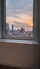 Fototapeta na wymiar Downtown Manhattan setting sun watched thru a window.