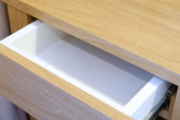 Empty opening drawer of a wood pattern table