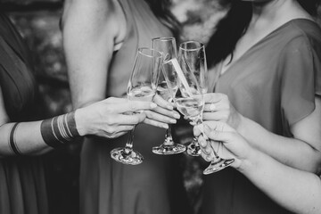 Women holding champagne glasses - black and white