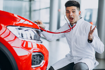 Car doctor with stethoscope in a car showroom