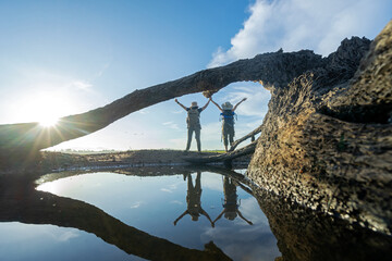 Group hiker woman travel and explore adventure raise hands  in nature. Asian people jumping relax for destination leisure landscape forest in summer day. Travel and lifestyle Concept.