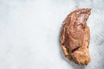 Raw marinated beef tri-tip steak for roast. White background. Top view. Copy space