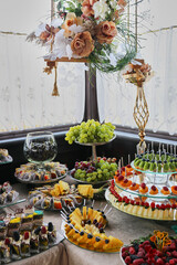 Sweet buffet table with different fruits. Dessert. Decoration of a buffet table.