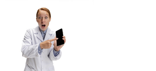 Using phone. Portrait of female doctor, therapeutic or medical advisor showing smartphone screen. Funny meme emotions. Concept of healthcare, care medicine and humor