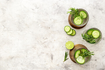 Cold fresh cocktail with lemon slices cucumber and rosemary
