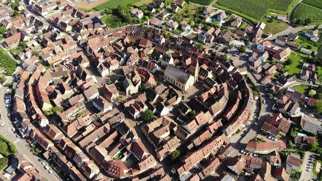 Top view of small Alsatian village. Aerial shot of Eguisheim, famous commune near Colmar town. Popular tourist attraction, part of well-known Alsace wine route