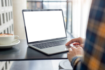 Fototapeta premium computer screen blank mockup.hand woman work using laptop with white background for advertising,contact business search information on desk at coffee shop.marketing and creative design