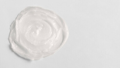 Fototapeta na wymiar The texture of the lip balm. Transparent ointment on a white background and copy space