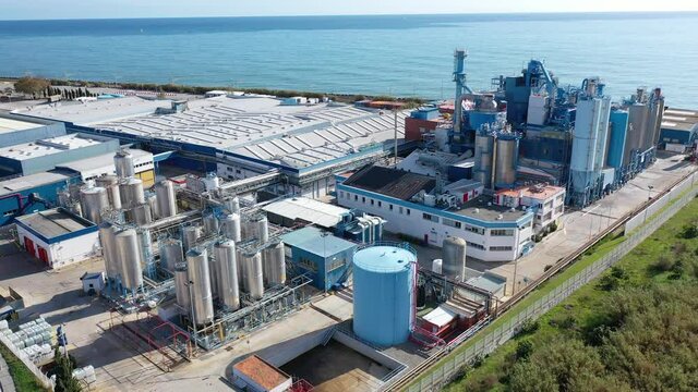 Aerial view of industrial facilities of Mataro factory producing detergent and air fresheners, Costa del Maresme, Spain