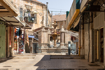 Empty street Al Souq with shops and restaurants closed due to coronavirus and fountain Muristan in...
