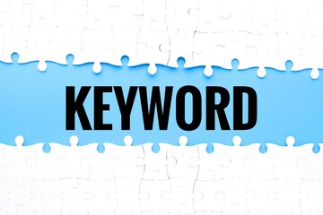Split puzzle with KEYWORD word on blue background.