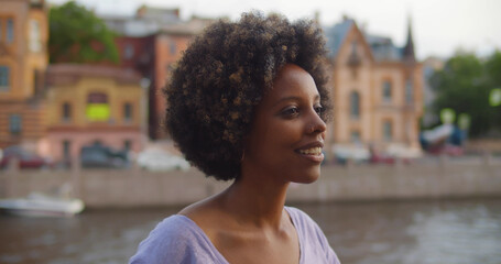 Close up portrait of beautiful african standing on city street