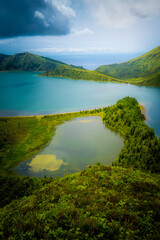 Fototapeta na wymiar Lagoa do Fogo surrounded by forests in a bright summer afternoon